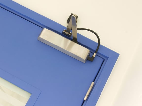 Close-Up-Of-Door-Closer-On-Postformed-Door-Ironmongery-